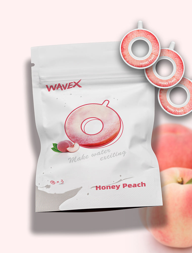 A bag of Honey Peach Flavor Taste Buds (3-pack) placed next to a peach, showcasing a vibrant and playful design.